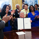 President Donald Trump shows the signed executive order supporting black colleges and universities in the Oval Office of the White House February 28, 2017 in Washington, DC.